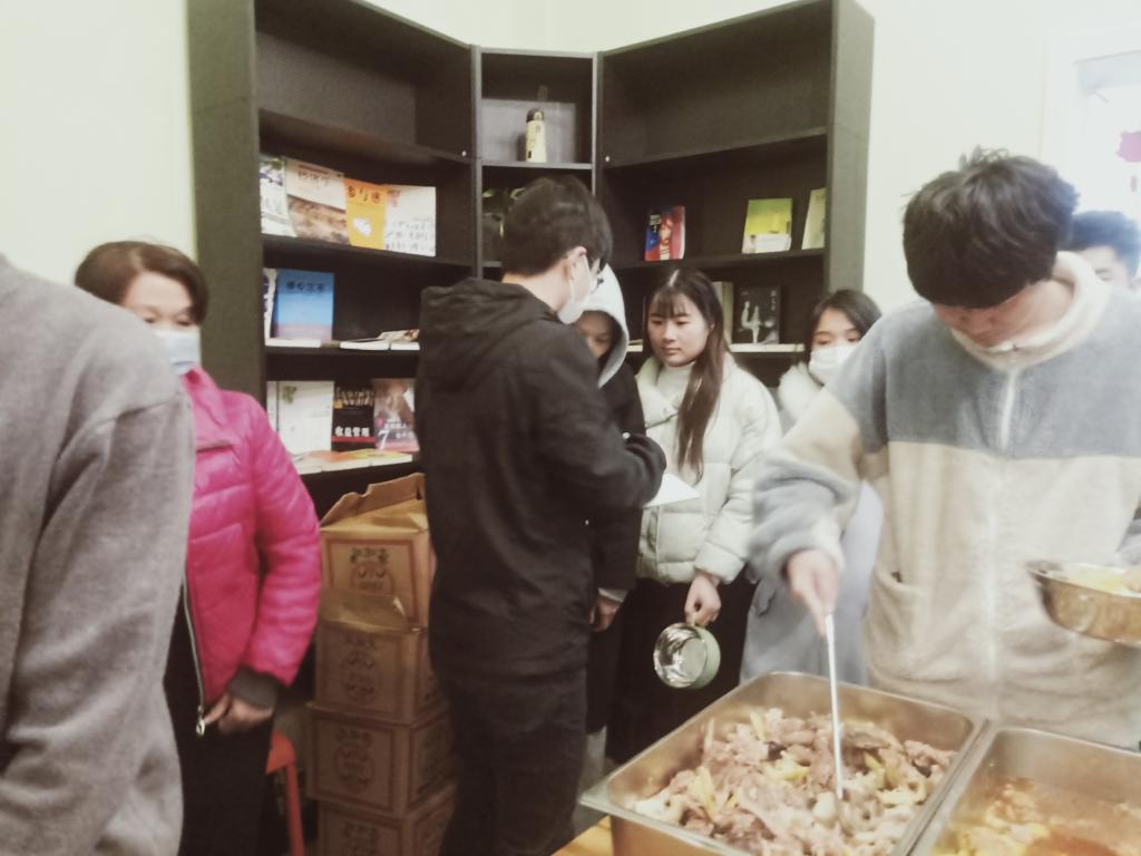 郭云飞同学维持实习单位滞留人员的用餐秩序(左三)